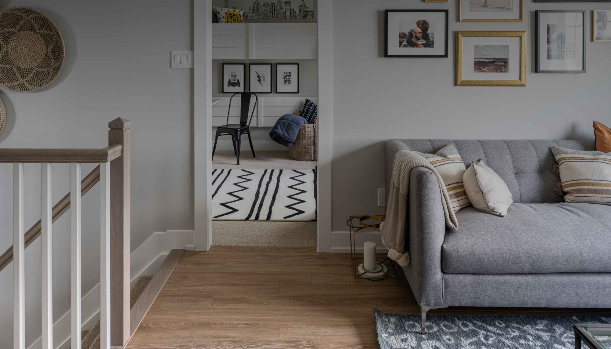 A furnished landing and living space beside a stair railing.