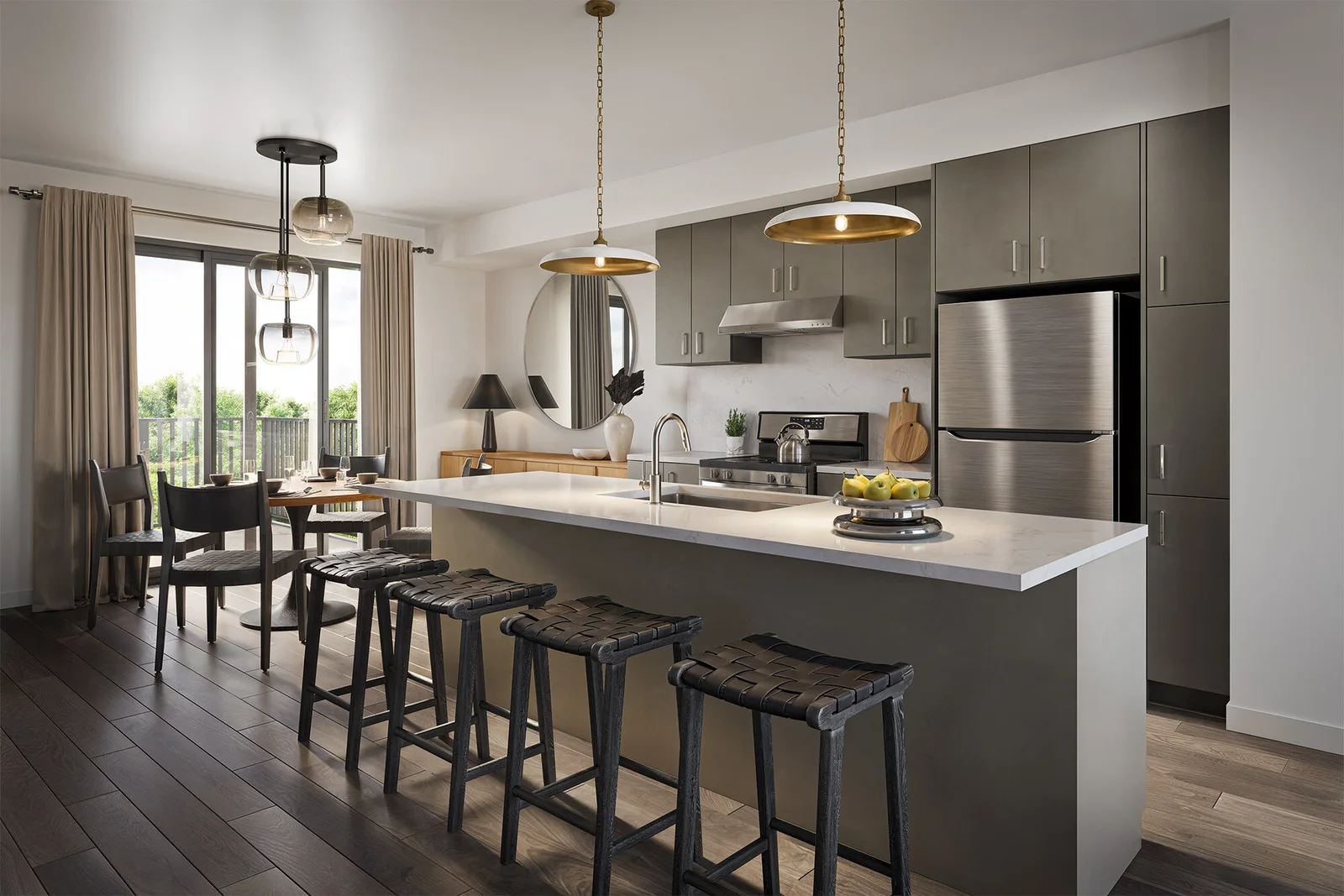 Bright modern kitchen with long island, woven barstools, brass pendants and stainless appliances.